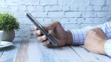 Man using smartphone on table video