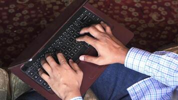 A man typing on a laptop computer video