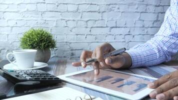 Man using tablet and calculator at desk video