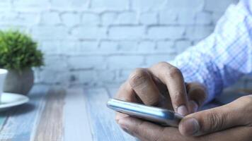 Man using mobile phone on table video