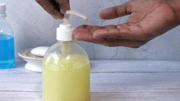 A person is using a hand sanitizer to clean a bottle video
