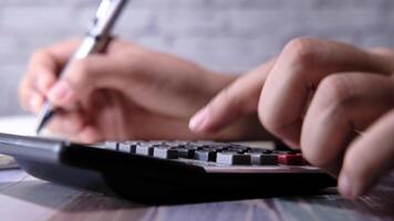 A person is using a calculator to do some math video