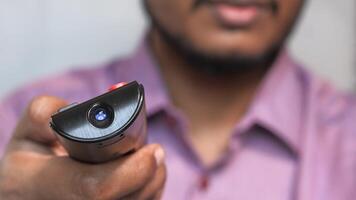 A man holding a remote control in his hand video