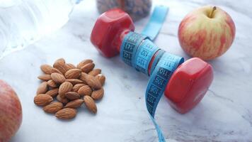 A scale, measuring tape and apples on a marble counter video