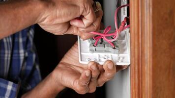A man is fixing a light switch with wires video