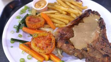 A plate of food with a side of fries and carrots video