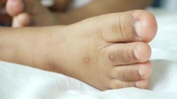 A child's foot with a white sheet on top video