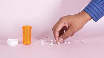 A person is holding a pill bottle and a pill container video
