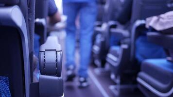 A person is walking down the aisle of an airplane video