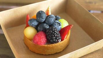 A box with a pastry with fruit on it video