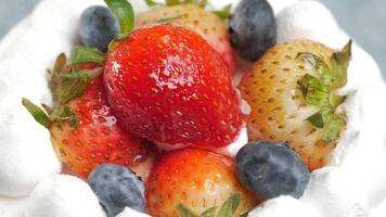 A close up of a cake with strawberries and blueberries video