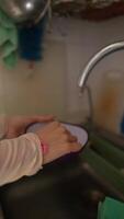 The activity of washing dishes at the home kitchen sink involves various tasks and utensils video