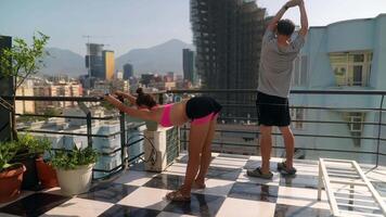 Experience Urban Fitness on a Rooftop While Enjoying a Scenic View of the City Skyline video