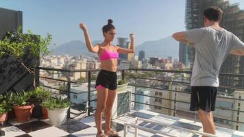 A Dynamic Duo Actively Engaging in Outdoor Fitness Activities on a Rooftop Space video