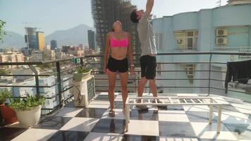 Engaging in a Dynamic Dance Pose on a Rooftop with a Stunning and Amazing City View Surrounding video