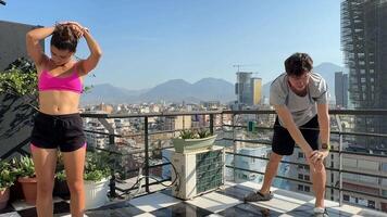 A group of Fitness Enthusiasts are Exercising on a Rooftop with a Stunning Scenic View video