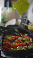 A Beautiful Display of Colorful StirFried Vegetables Cooked on a Black Griddle Surface video