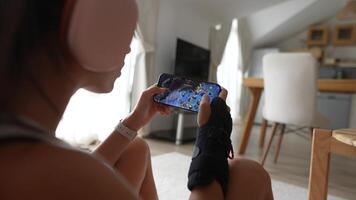 A Casual Gamer Who Is Enjoying a Mobile Game in a Very Stylish and Comfortable Setup video