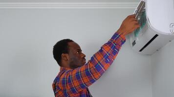 Technician in uniform check and cleaning filters of air conditioner. Air condition maintenance service video