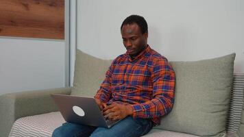 African american man software developer programming codes while working from home video