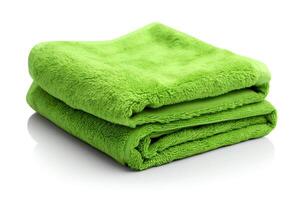 Generate a high-resolution image of a green towel folded in half on a white background. The towel should be soft and fluffy, with a plush texture. photo