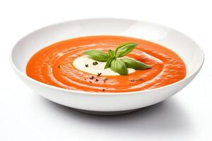 This is a bowl of creamy tomato soup. The soup is made with fresh tomatoes, cream, and herbs. It is garnished with a swirl of cream and a sprig of basil. photo