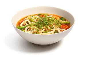 A bowl of udon noodles in a light broth with vegetables. The noodles are topped with a sprinkle of green onions and red pepper flakes. photo