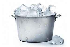 A stainless steel ice bucket filled with clear ice cubes. There is one ice cube that has fallen outside the bucket on the right side. photo