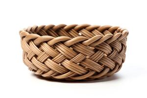 An empty wicker basket sits on a white table. The basket is made of natural materials and has a rustic appearance. photo