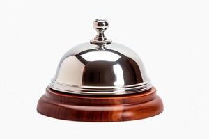 A hotel service bell sits on a wooden table. photo