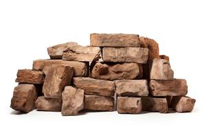 A pile of red bricks, isolated on a white background. The bricks are old and weathered, with a variety of textures and colors. photo