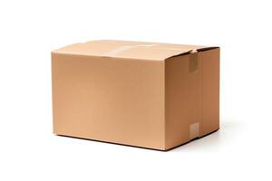 A brown corrugated cardboard box is sitting on a white surface. The box is closed and has white tape on the top and bottom. photo