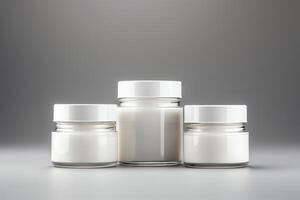 3D rendering of a set of three cosmetic jars with white cream on a gray background photo