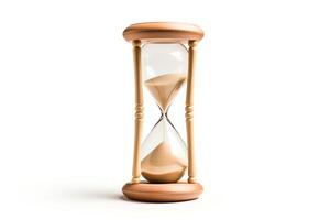 An hourglass timer sits on a white surface. The sand is tricking down in the bottom half of the timer. photo