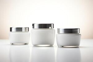 3D rendering of a set of three cosmetic cream jars with silver lids on a white background photo
