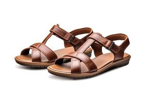 Take a photo of a pair of brown leather sandals with adjustable hook-and-loop closure straps