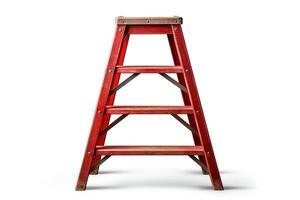 A red wooden stepladder is isolated on a white background. The ladder is four steps tall and has a metal hinge. photo
