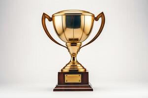 A gold trophy with a blank nameplate sits on a wooden base. The trophy is isolated on a white background. photo