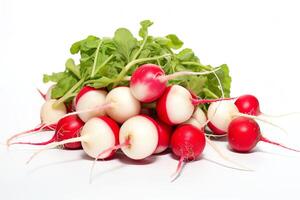 A pile of fresh radishes on a white background. The radishes are red and white, and have green leaves. photo