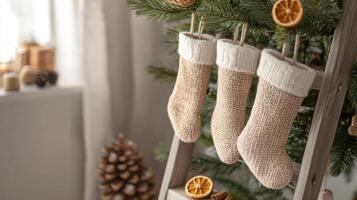 Minimalist Christmas scene with organic stockings and a simple tree decorated with dried oranges, capturing a peaceful, natural holiday atmosphere. Christmas stockings, New Year photo