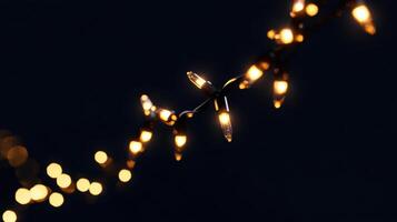 Single strand of warm white Christmas lights glowing in the dark, minimalist design with sharp contrasts and focus on simplicity. Christmas photo