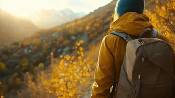 Cozy fleece jacket on a hiker, standing at the edge of a rugged mountain trail, autumn colors and crisp air creating a serene scene. Autumn clothing photo