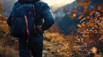Hiker wearing a cozy fleece jacket on a mountain trail, autumn leaves surrounding, the jacket's softness contrasting with the rugged terrain. Autumn clothing photo