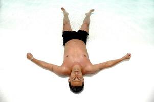 Man relaxing in pool photo