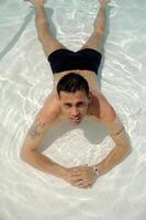 Man relaxing in pool photo