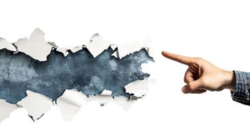 A business concept image shows a hand in a suit pointing at torn paper, symbolizing breakthrough and innovation. The minimalist, abstract design emphasizes creativity, disruption, and modern corporate photo
