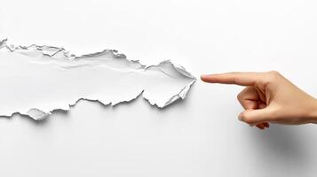A business concept image shows a hand in a suit pointing at torn paper, symbolizing breakthrough and innovation. The minimalist, abstract design emphasizes creativity, disruption, and modern corporate photo