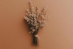 An elegant bundle of dried herbs, intricately bound, evokes a sense of rustic charm. The warm backdrop enhances the natural beauty and earthy tones, creating a serene atmosphere. photo