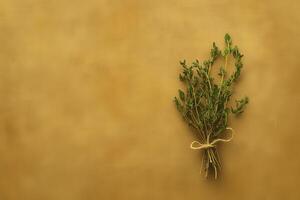 An isolated bundle of dried herbs is tied together with twine, showcasing its rustic beauty against a warm, textured background. The arrangement exudes a natural, calming essence. photo