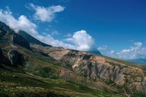 Mountain valley with blue sky and clouds photo